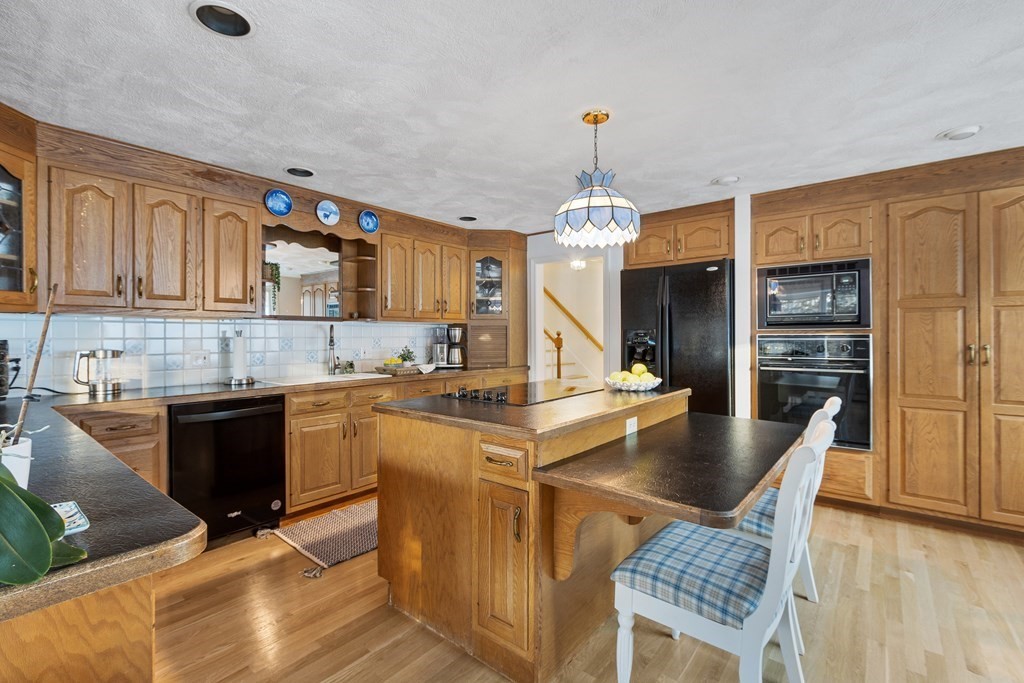 420 Old Harvard Road Boxborough, MA 01719 - Photo 4 of 37 a kitchen with stainless steel appliances granite countertop a sink stove and refrigerator