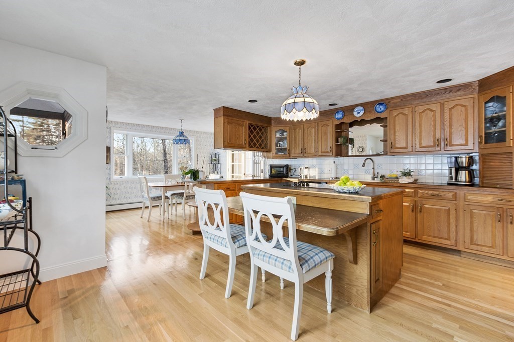 420 Old Harvard Road Boxborough, MA 01719 - Photo 5 of 37 a kitchen with stainless steel appliances granite countertop a stove a sink dishwasher and a refrigerator with wooden floor