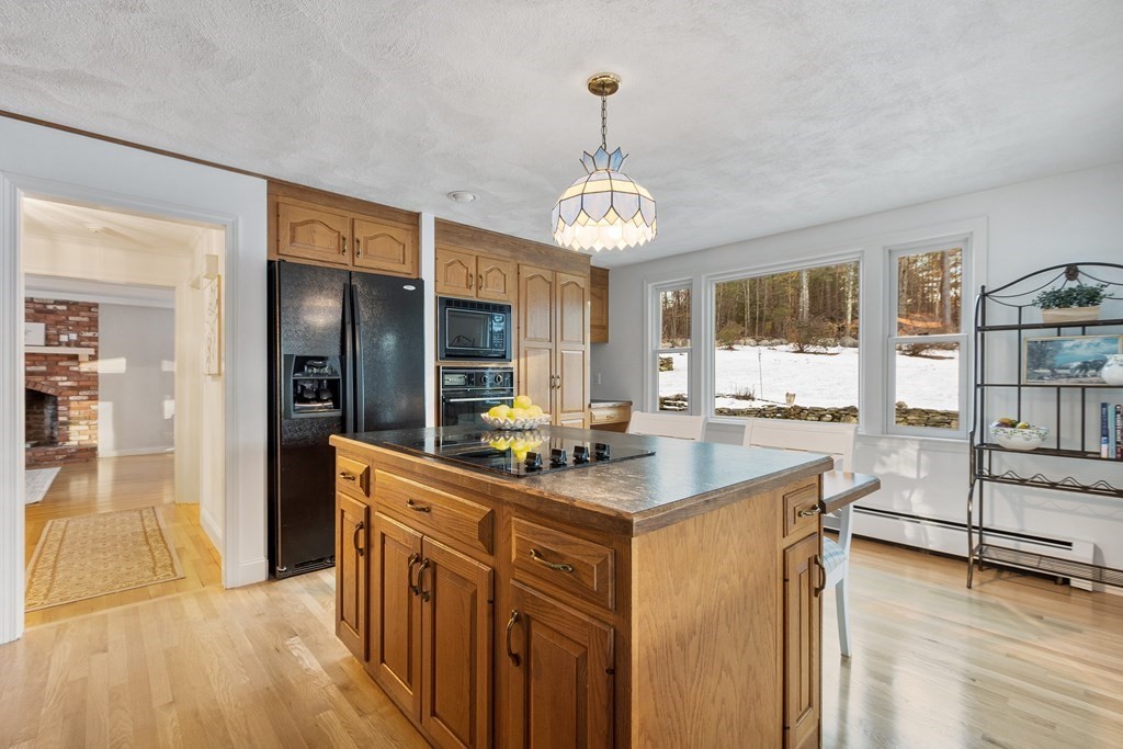 420 Old Harvard Road Boxborough, MA 01719 - Photo 7 of 37 a kitchen with stainless steel appliances granite countertop a sink stove and refrigerator