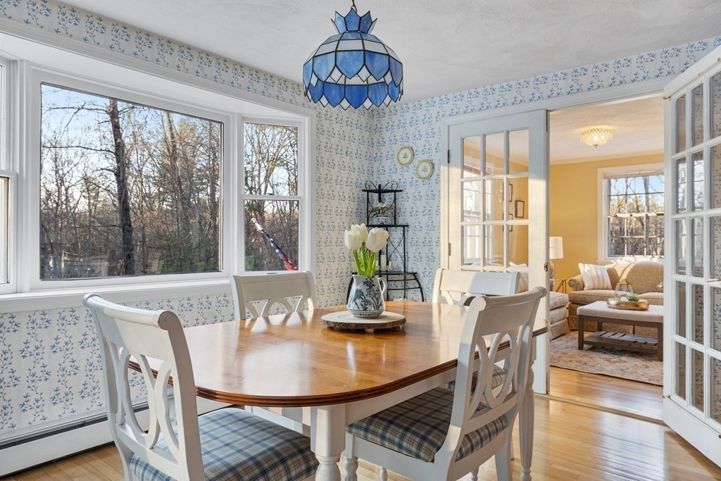 420 Old Harvard Road Boxborough, MA 01719 - Photo 9 of 37 a dining room with furniture a chandelier and wooden floor