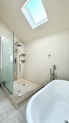 a bathroom with a granite countertop sink a toilet and shower
