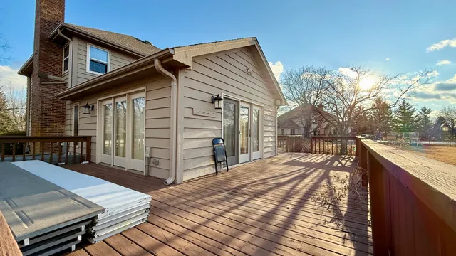 a view of a house with wooden deck