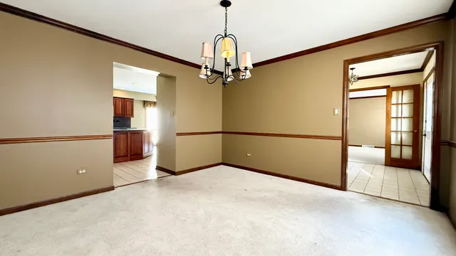 a view of a hallway with a chandelier