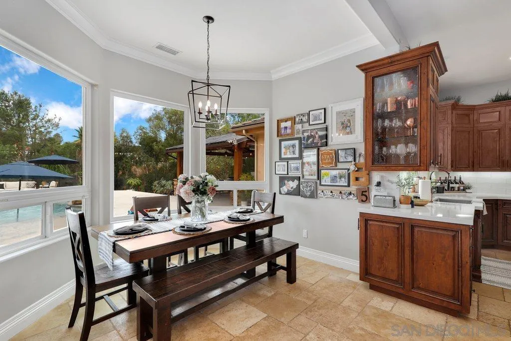 11130 Boulder Pass Escondido, CA 92026 - Photo 11 of 55 a dining room with furniture a chandelier and wooden floor