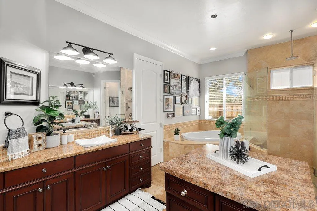 11130 Boulder Pass Escondido, CA 92026 - Photo 18 of 55 a bathroom with a granite countertop sink a large mirror and shower