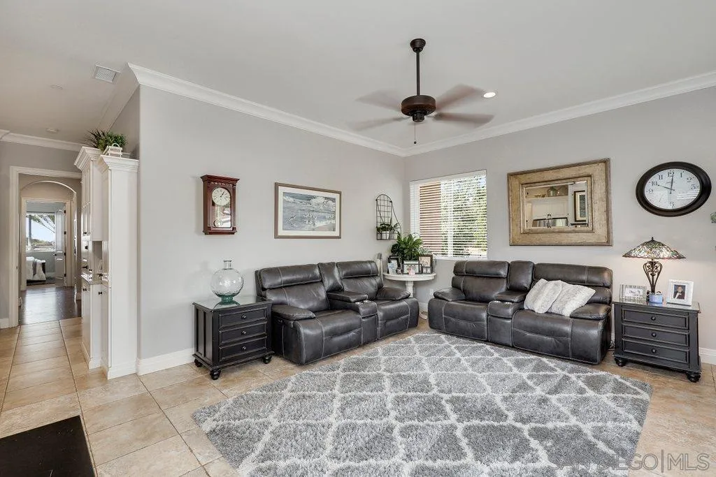 11130 Boulder Pass Escondido, CA 92026 - Photo 29 of 55 a living room with furniture a clock on wall and a window