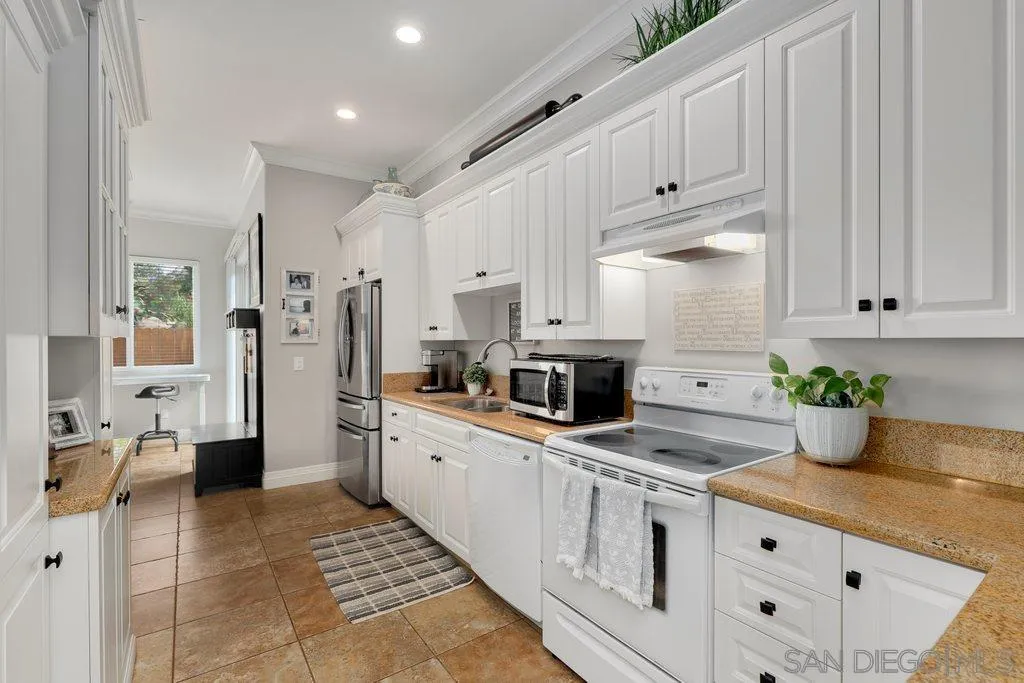 11130 Boulder Pass Escondido, CA 92026 - Photo 32 of 55 a large white kitchen with stainless steel appliances granite countertop a stove a sink and a refrigerator