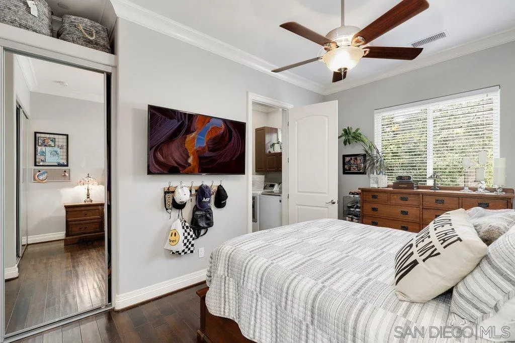 11130 Boulder Pass Escondido, CA 92026 - Photo 34 of 55 a bedroom with a large bed and a flat screen tv