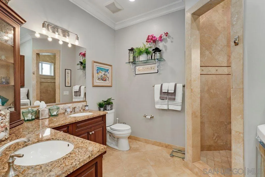 11130 Boulder Pass Escondido, CA 92026 - Photo 35 of 55 a bathroom with a granite countertop toilet a sink and a mirror