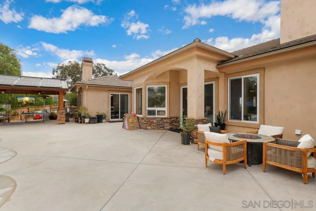 11130 Boulder Pass Escondido, CA 92026 - Photo 38 of 55 a view of a patio with couches and a table and chairs with wooden fence