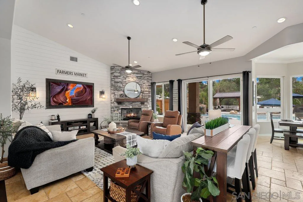 11130 Boulder Pass Escondido, CA 92026 - Photo 5 of 55 a living room with furniture a chandelier and a flat screen tv