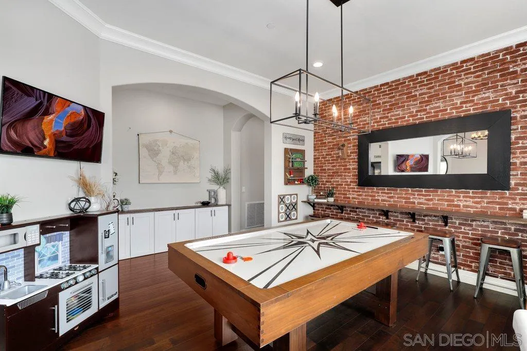 11130 Boulder Pass Escondido, CA 92026 - Photo 9 of 55 a living room with stainless steel appliances a table chairs and a flat screen tv