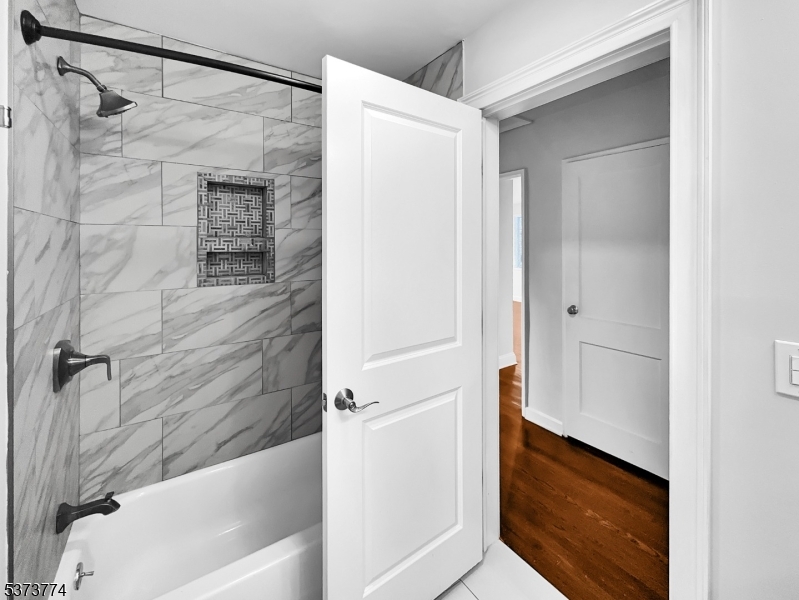 5 Troy Drive Springfield, NJ 07081 - Photo 15 of 21 a bathroom with a bathtub and a shower