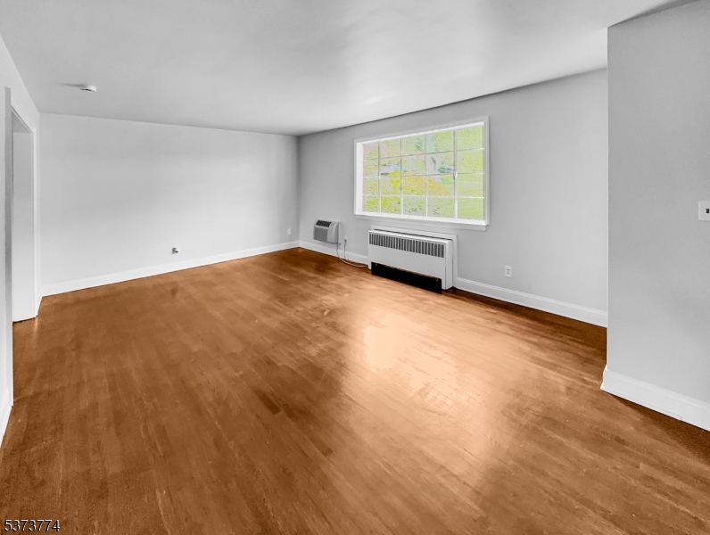 5 Troy Drive Springfield, NJ 07081 - Photo 3 of 21 a view of an empty room with wooden floor and a window