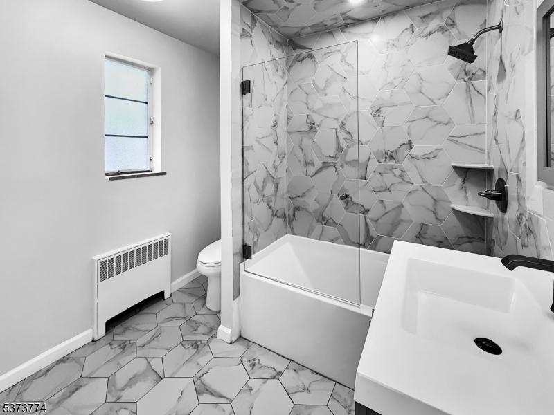 5 Troy Drive Springfield, NJ 07081 - Photo 7 of 21 a bathroom with a bathtub and a shower