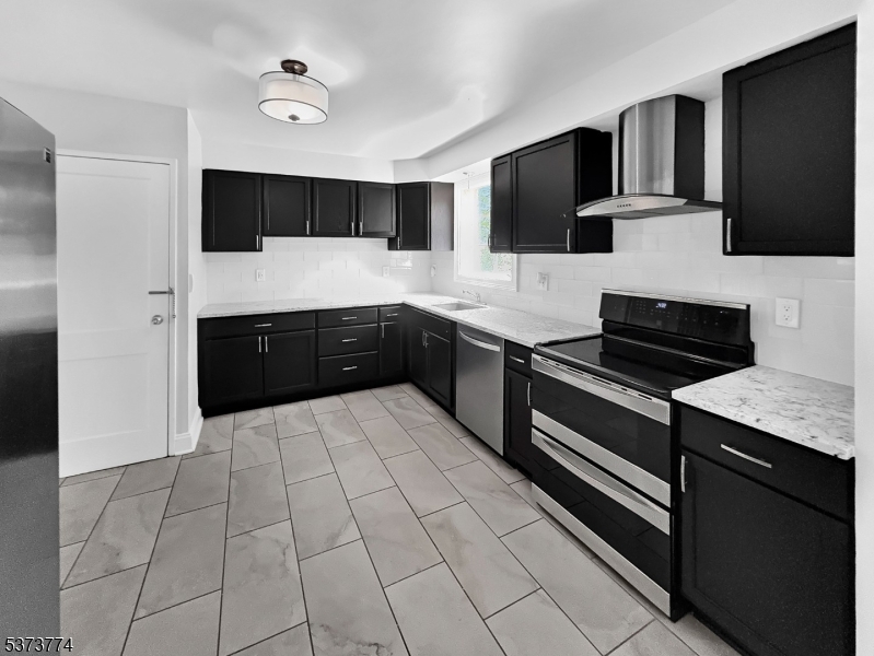 5 Troy Drive Springfield, NJ 07081 - Photo 10 of 21 a kitchen with stainless steel appliances a stove sink microwave and cabinets