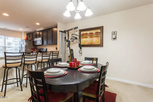a view of a dining room with furniture and chandelier
