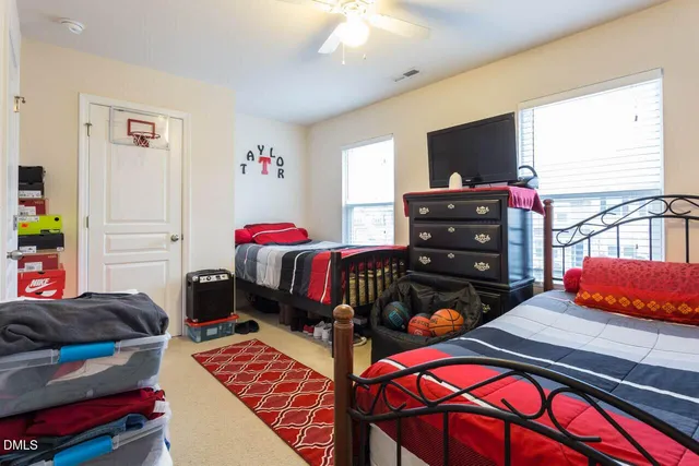 a bedroom with furniture and a flat screen tv