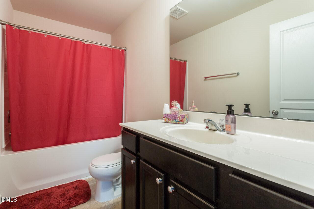 4009 Tresco Crossing Raleigh, NC 27616 - Photo 18 of 23 a bathroom with a sink a toilet and shower