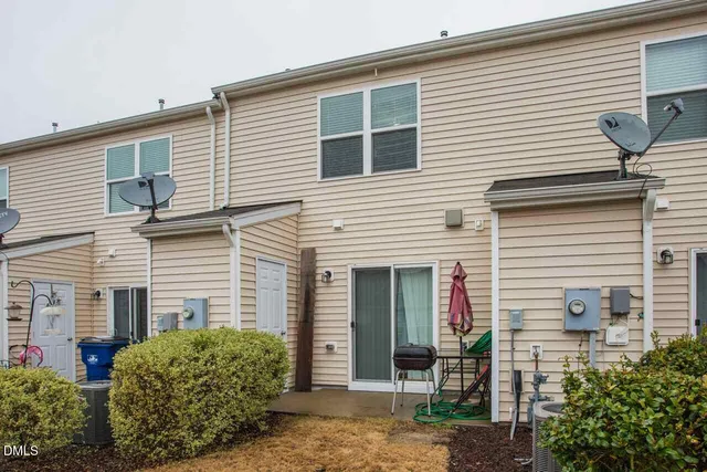 a view of a house with a yard and plants