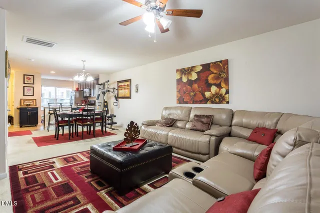 a living room with furniture and kitchen view