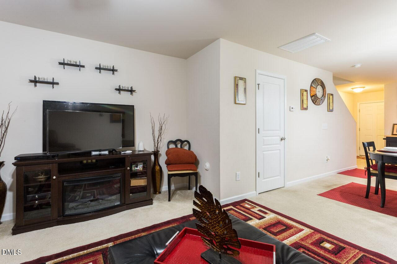 4009 Tresco Crossing Raleigh, NC 27616 - Photo 5 of 23 a living room with furniture and a flat screen tv