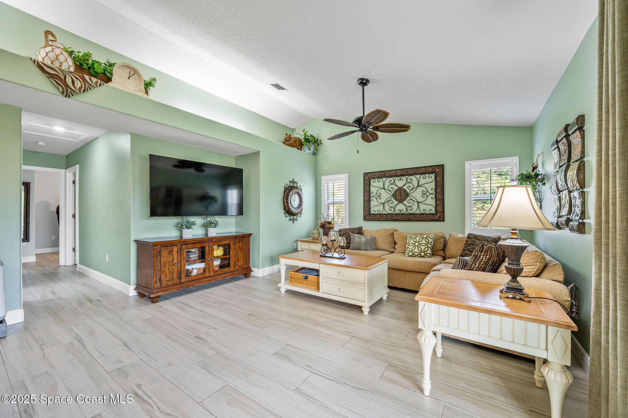 4385 Windover Way Melbourne, FL 32934 - Photo 24 of 44 a living room with furniture and a flat screen tv
