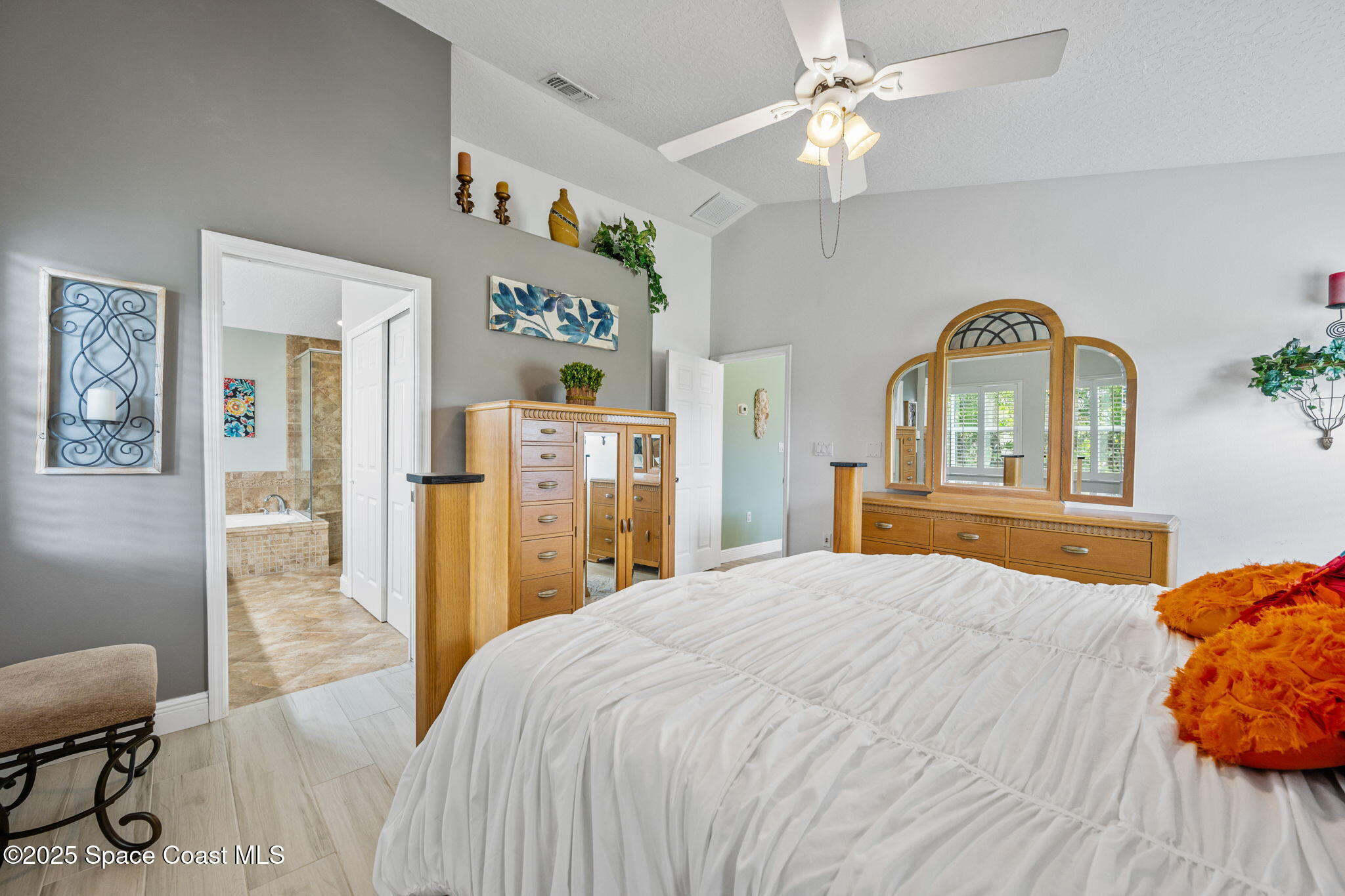 4385 Windover Way Melbourne, FL 32934 - Photo 27 of 44 a bedroom with a bed and a chandelier