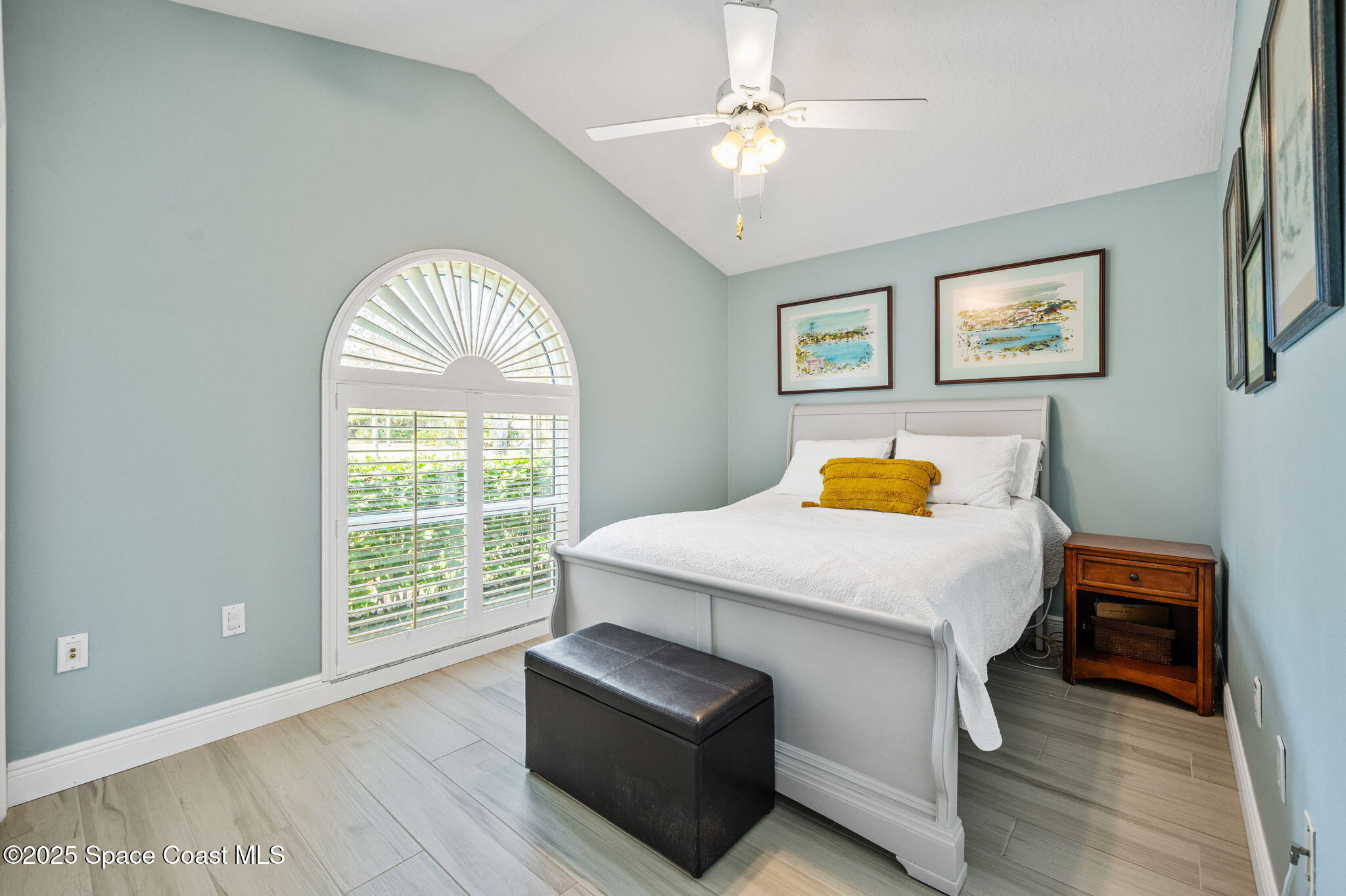 4385 Windover Way Melbourne, FL 32934 - Photo 32 of 44 a bedroom with a bed and a chandelier