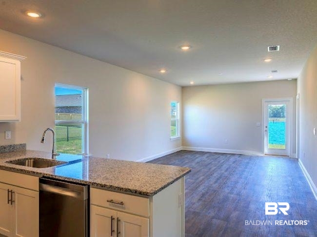 16810 Rocher Court Foley, AL 36535 - Photo 10 of 24 Open-concept living space featuring wood-finish flooring, recessed lighting, and ample natural light from multiple windows