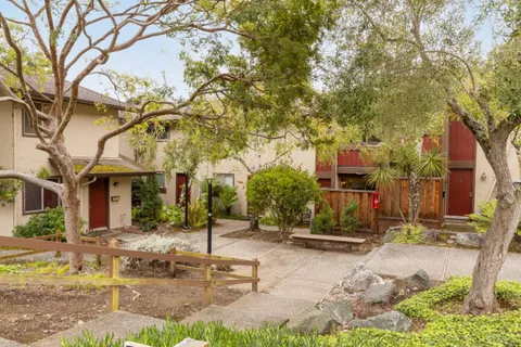 a view of a street with houses on both side