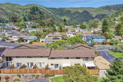 an aerial view of residential houses and outdoor space