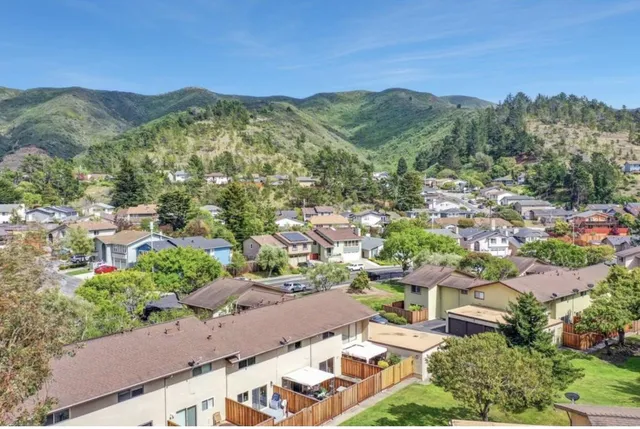 an aerial view of a houses with outdoor space and street view