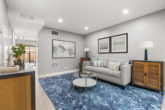 a living room with furniture and a chandelier