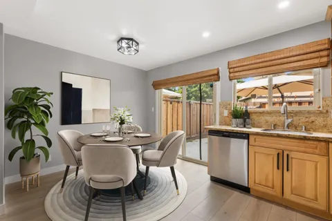 a dining room with furniture a rug and wooden floor