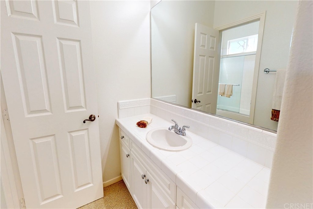 953 Clear Sky Place Simi Valley, CA 93065 - Photo 36 of 53 a bathroom with a sink and a mirror