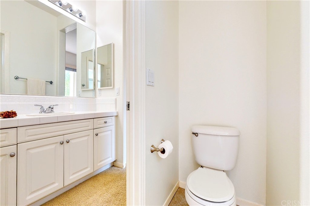 953 Clear Sky Place Simi Valley, CA 93065 - Photo 38 of 53 a bathroom with a toilet sink and mirror