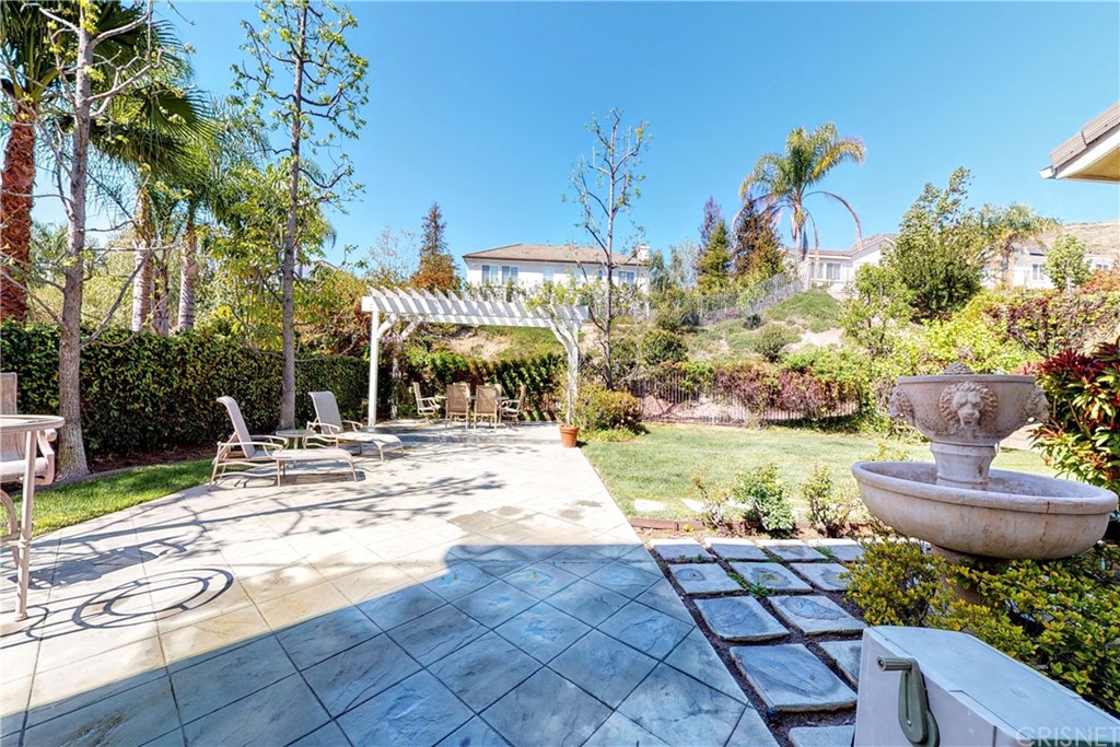 953 Clear Sky Place Simi Valley, CA 93065 - Photo 43 of 53 a view of a patio with table and chairs potted plants and large tree