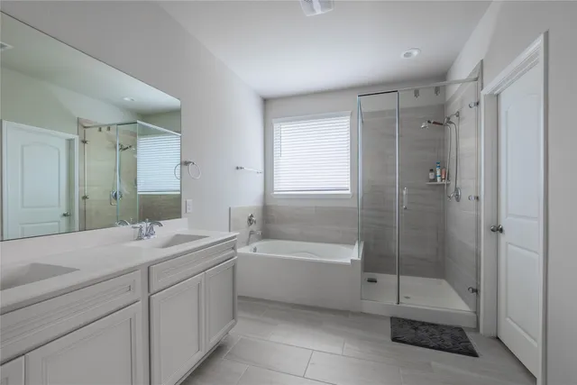 a bathroom with a double vanity sink toilet and shower