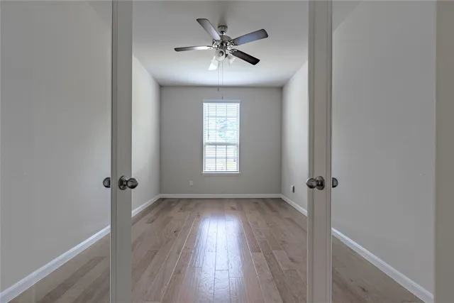 wooden floor in an empty room with a window