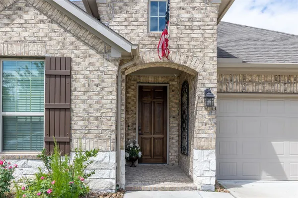 a front view of a house with plants