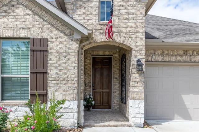 a front view of a house with plants