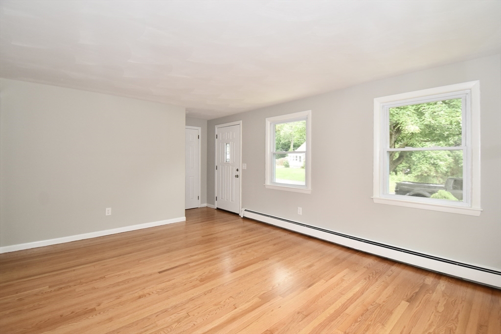 94 David Street Springfield, MA 01104 - Photo 17 of 39 an empty room with wooden floor and windows