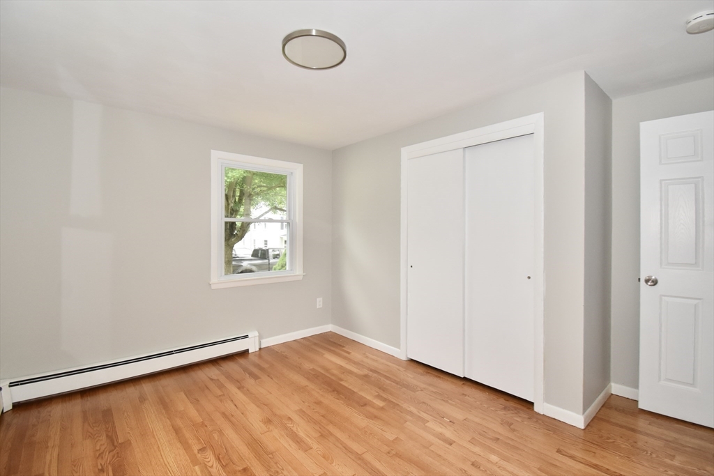 94 David Street Springfield, MA 01104 - Photo 18 of 39 an empty room with wooden floor and window