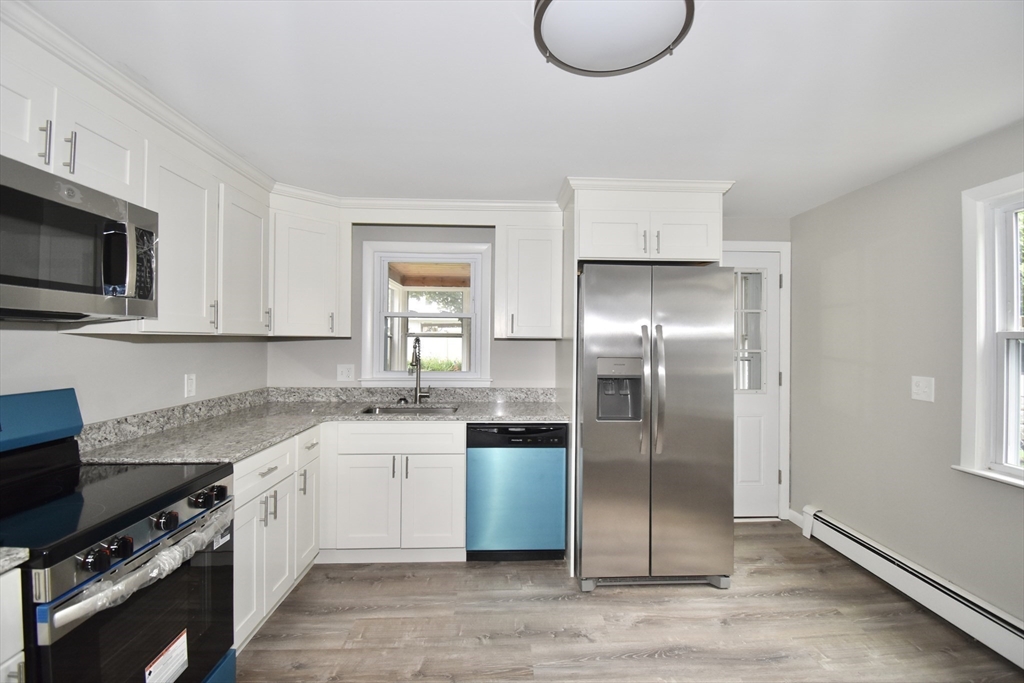 94 David Street Springfield, MA 01104 - Photo 2 of 39 a kitchen with a sink dishwasher a refrigerator and a stove