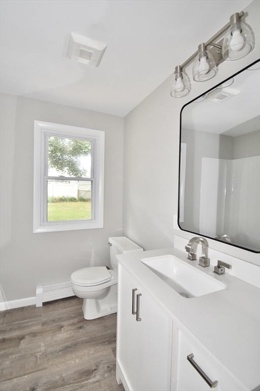 94 David Street Springfield, MA 01104 - Photo 24 of 39 a bathroom with a granite countertop toilet a sink and a mirror