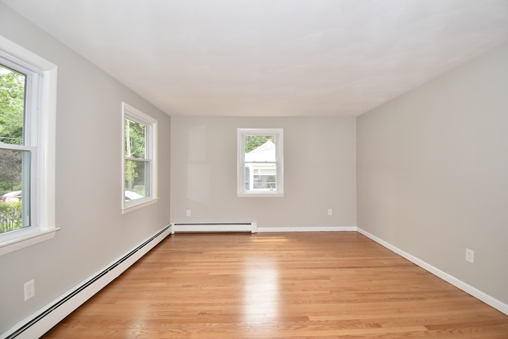 94 David Street Springfield, MA 01104 - Photo 26 of 39 an empty room with wooden floor and windows