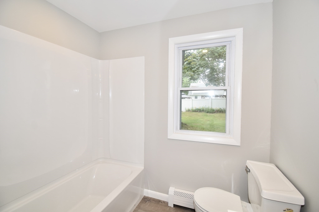 94 David Street Springfield, MA 01104 - Photo 28 of 39 a white bath tub sitting next to a window