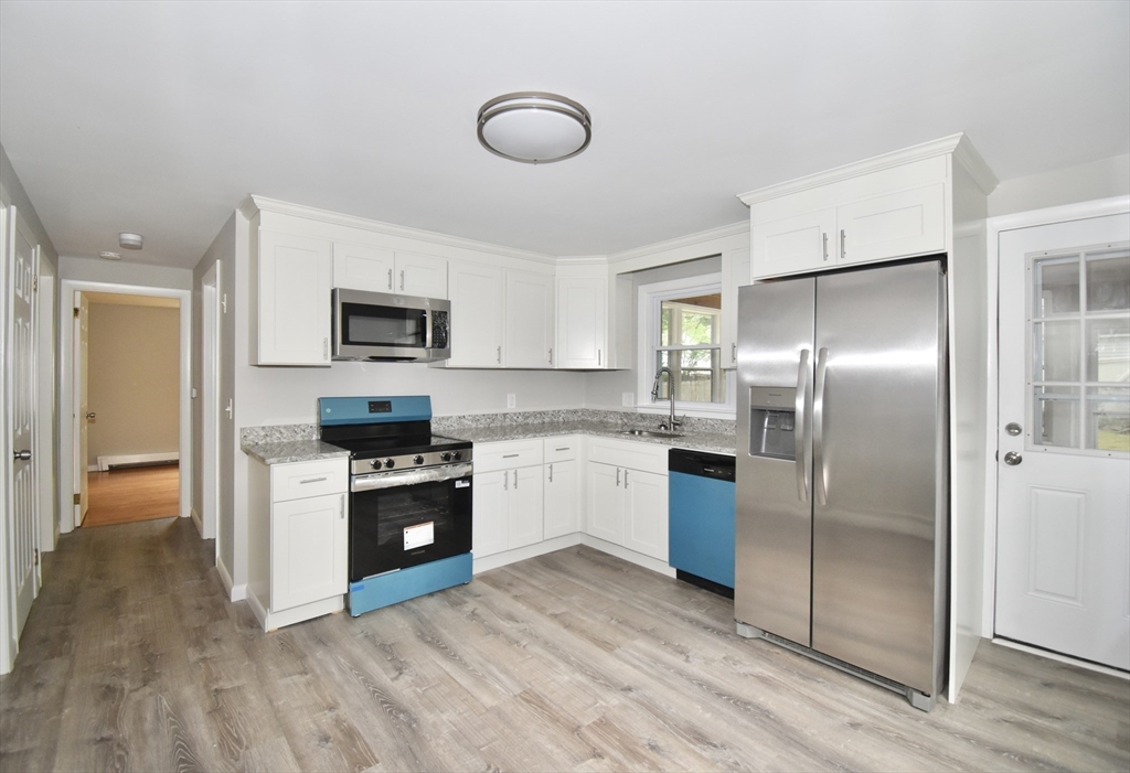 94 David Street Springfield, MA 01104 - Photo 3 of 39 a kitchen with a refrigerator and a stove top oven