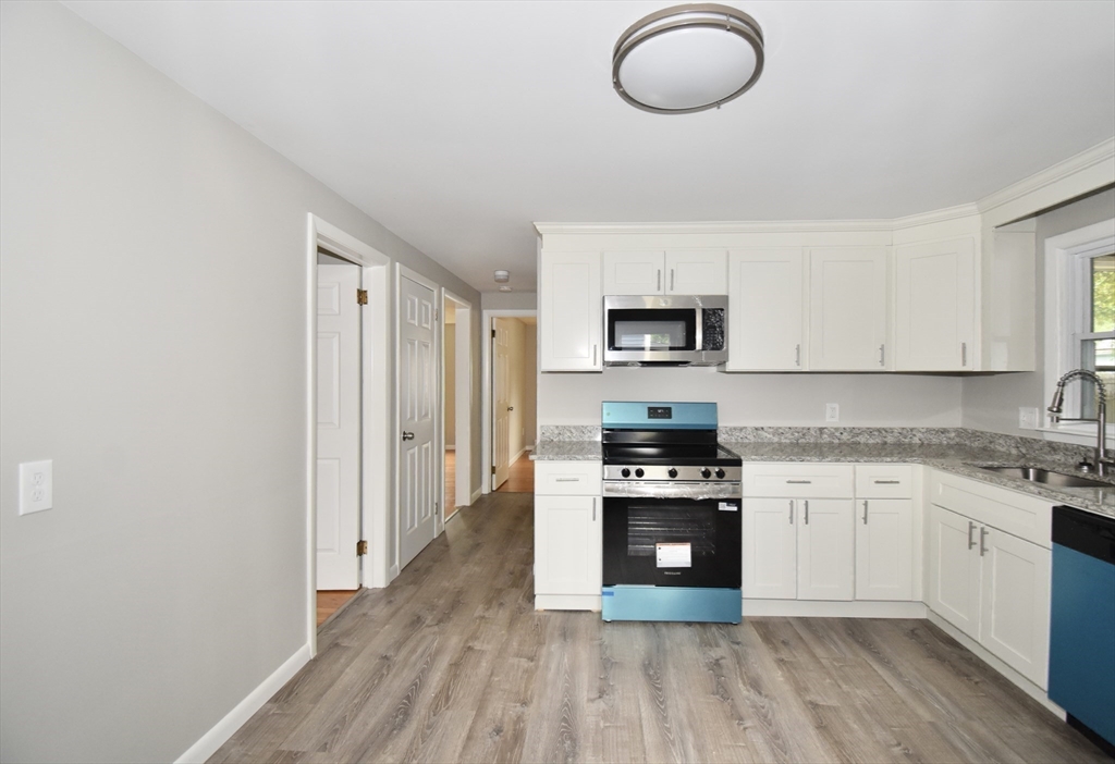94 David Street Springfield, MA 01104 - Photo 7 of 39 a kitchen with cabinets appliances and a wooden floor